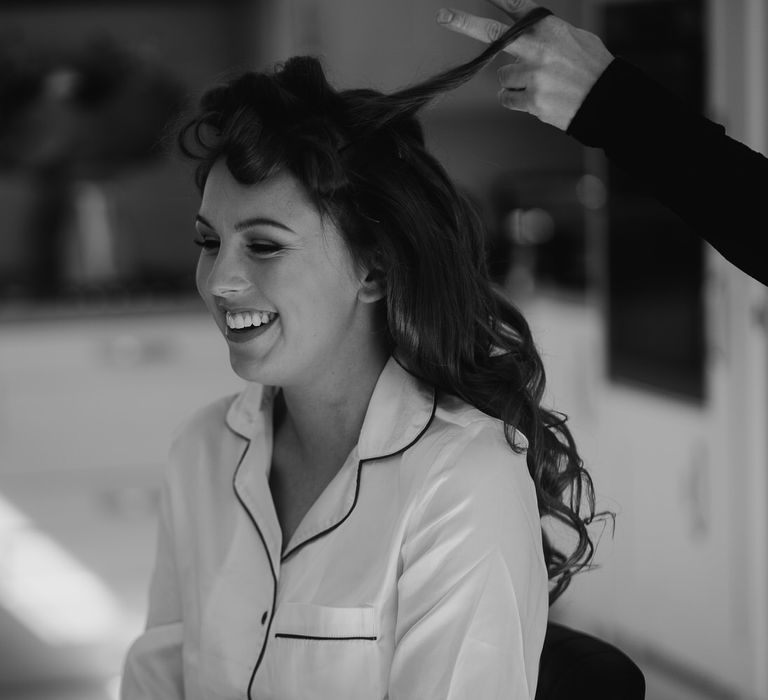 Bride having her hair put in curl rollers