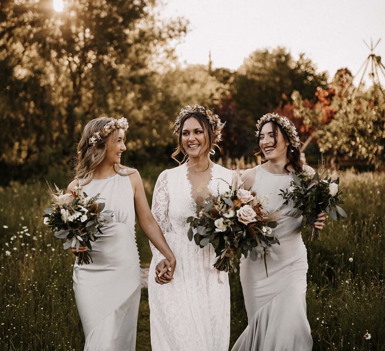 Golden hour bridal party portrait with bride and bridesmaids wearing a dried flower crown