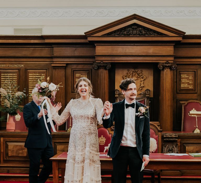 Bride & groom stand at the front of the aisle after their wedding ceremony for Town Hall wedding