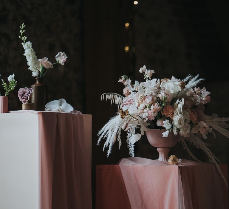 Pampas grass bouquets filled with pastel pink florals