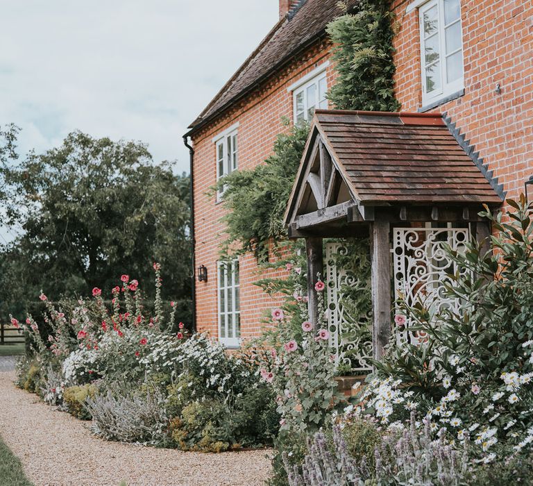 Exterior of brick farmhouse at Primrose Hill Farm for summer wedding