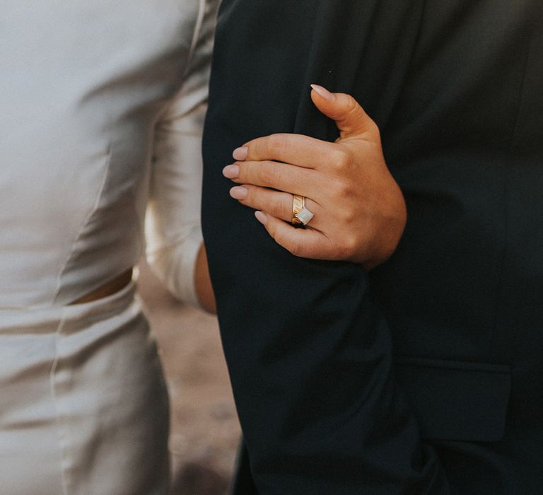 Bride holds her grooms arm