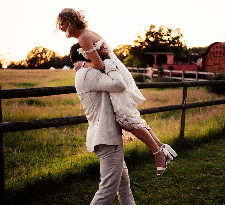 Groom lifts bride in the air at Preston Court wedding