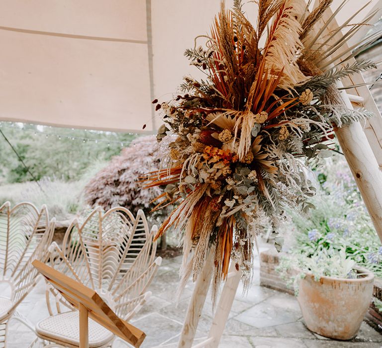 wooden frame altar decorated with orange dried flowers 