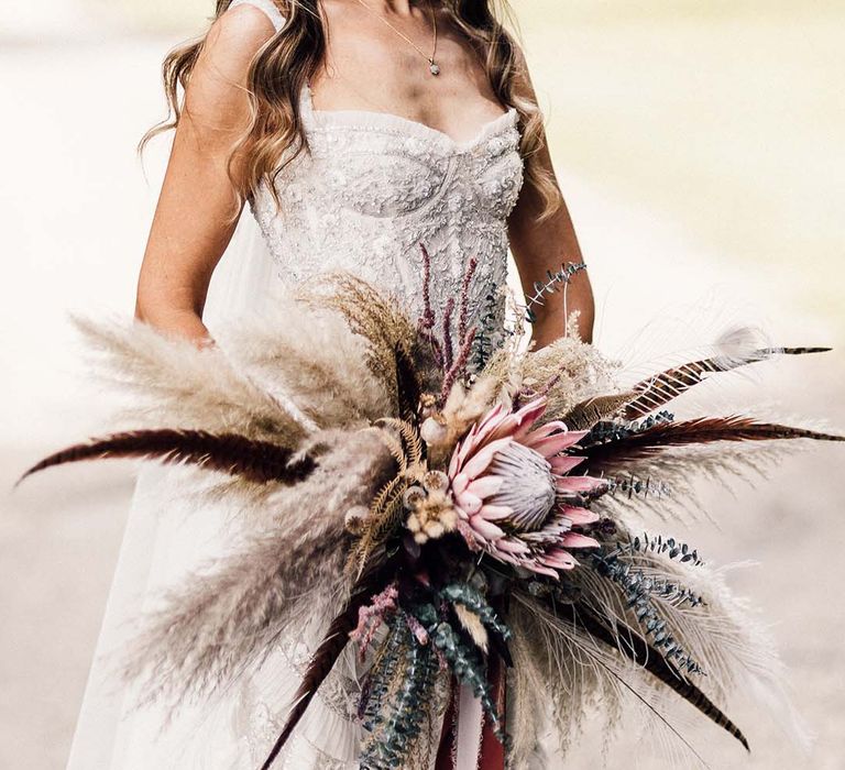 Bride holds impressive floral bouquet on her wedding day