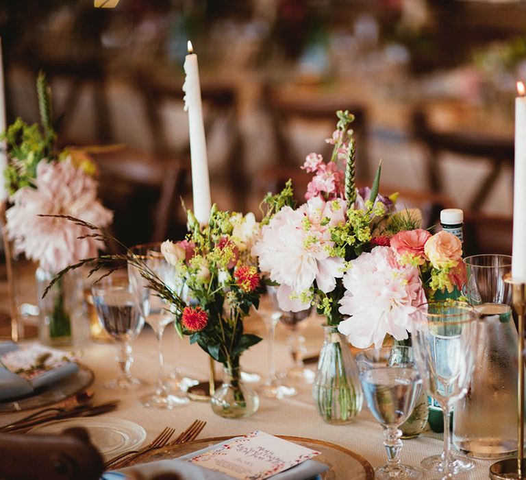 Colourful florals on wooden tables in tipi 