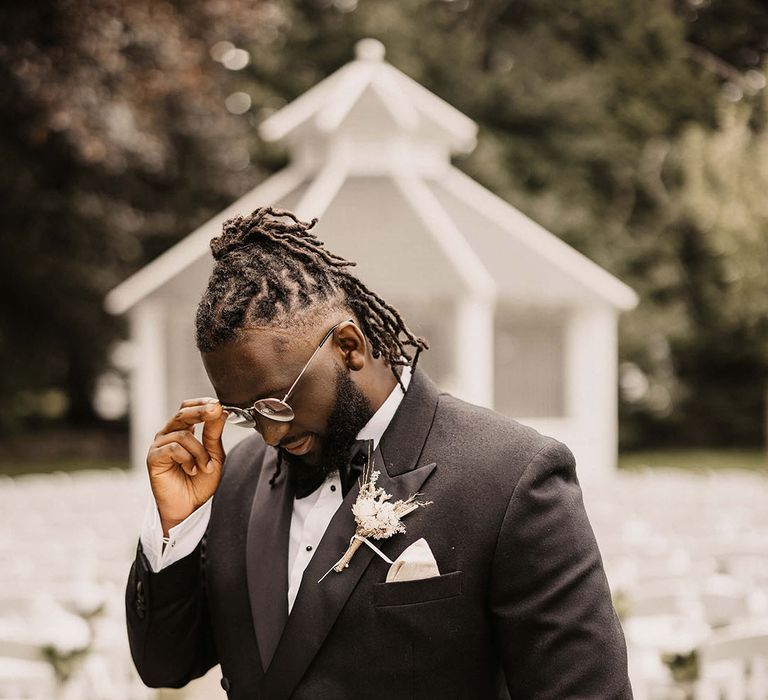 Groom wears black tie on his wedding day at Haynes House