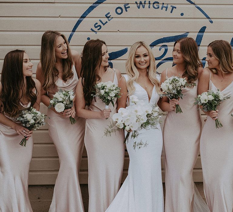 Champagne bridesmaid dresses with white flower bouquets