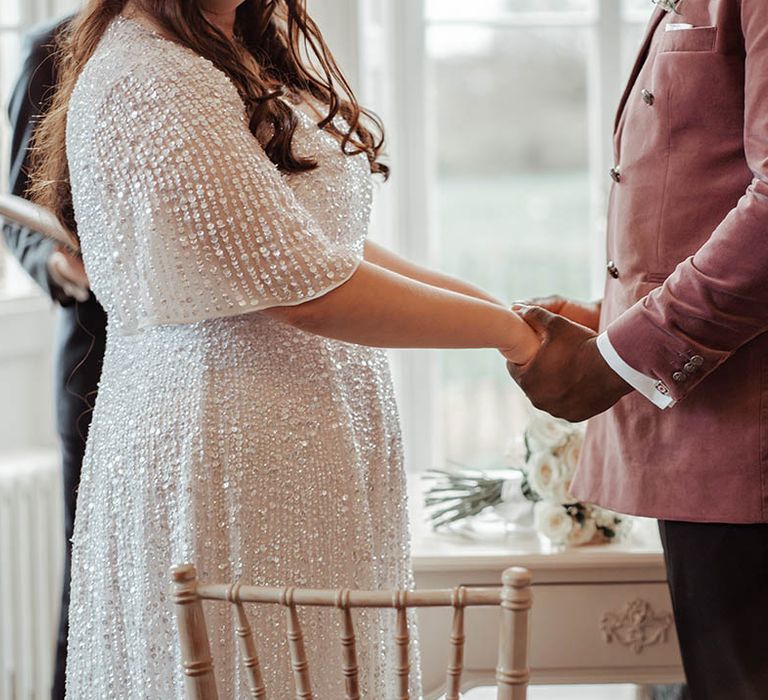 Bride & groom hold hands on their wedding day