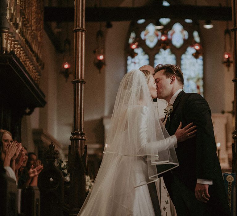 Bride and groom at the alter, bride in long white wedding dress and veil at Hedsor House wedding 