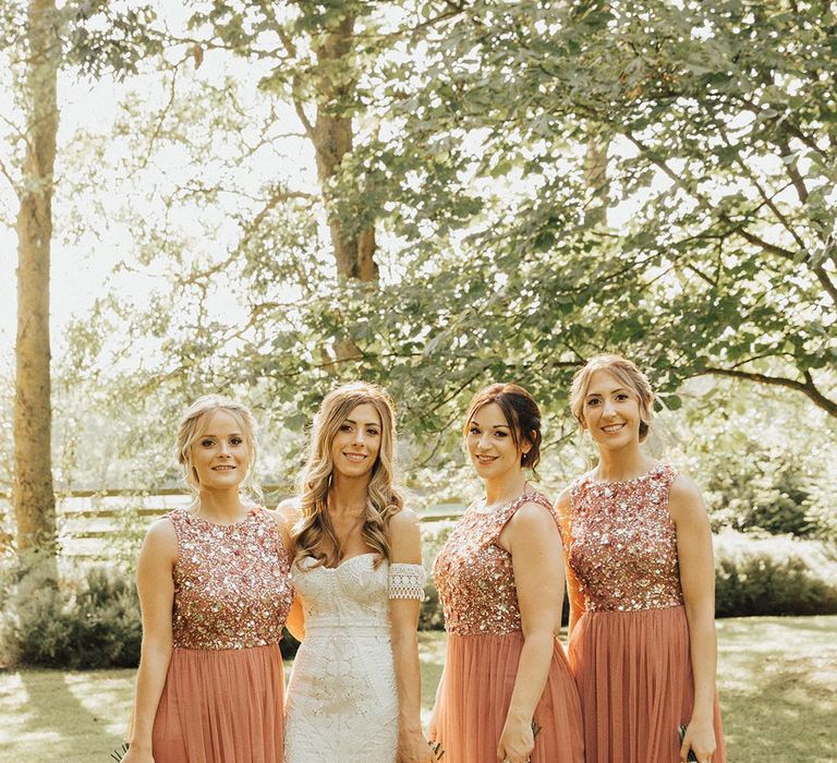 Bridesmaids in orange embellished bridesmaid dresses with sequins 