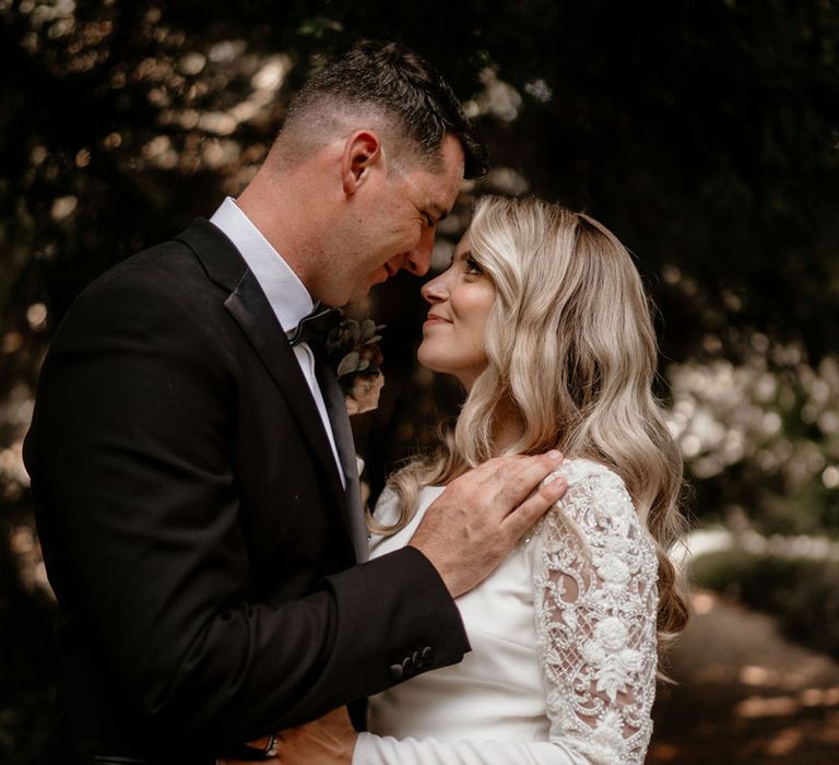 Bride and groom look into each other's eyes for their classic black tie wedding 