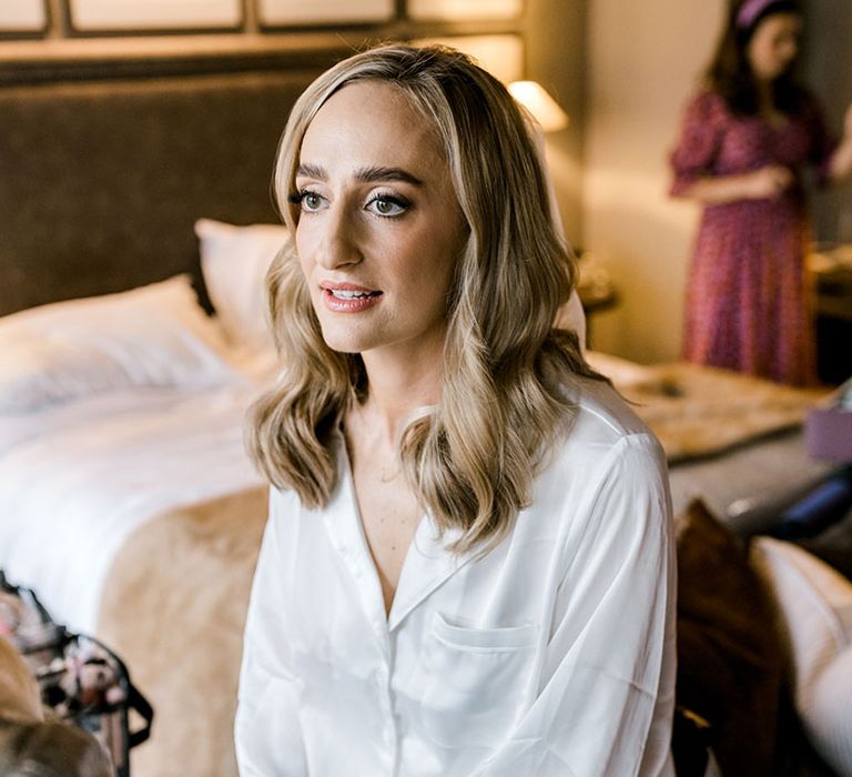 Bride wears her blonde hair in natural loose curls 