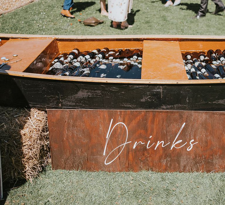 Wedding canoe boat filled with cold water, ice, and beer to keep the wedding drinks cold 