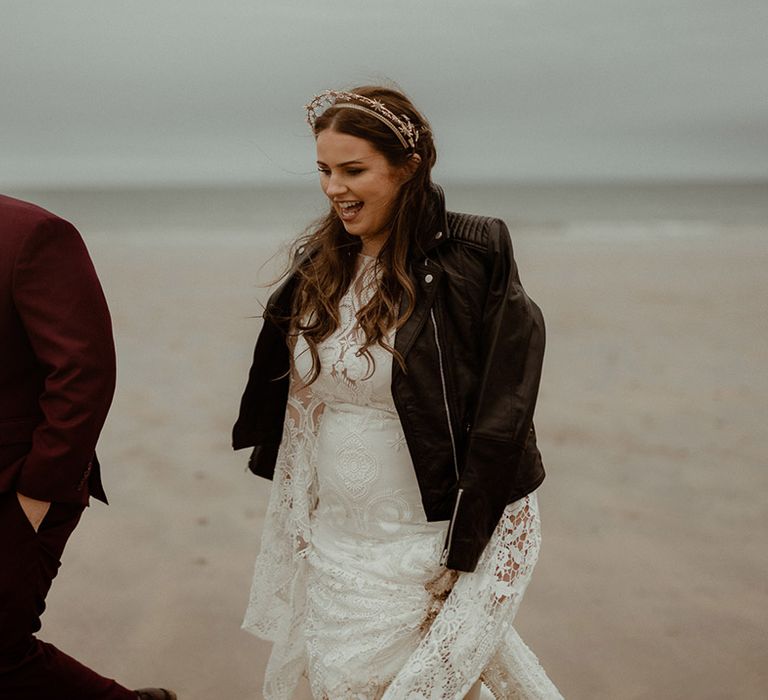 Bride in boho lace wedding dress with black leather jacket cover up with personalised design 