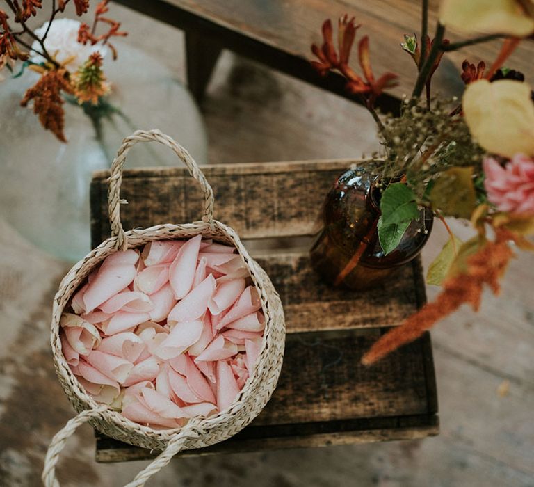 fresh pink flower petals in a wicker basket for confetti