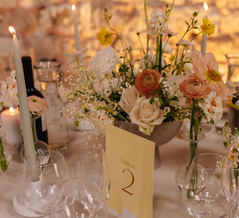 Pastel yellow and white spring wedding at Lulworth Castle with yellow table number sign