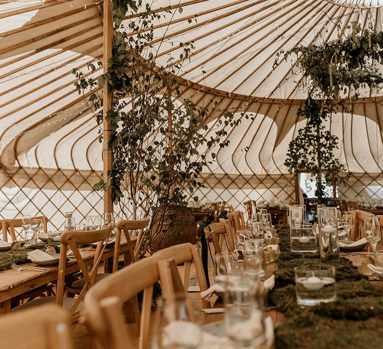 Yurt wedding reception venue for Camp Katur wedding in Yorkshire decorated with lots of foliage and greenery 