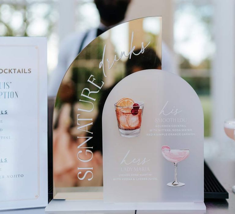 Mirrored acrylic wedding cocktail sign at Syon Park with pink wedding cocktails next to it