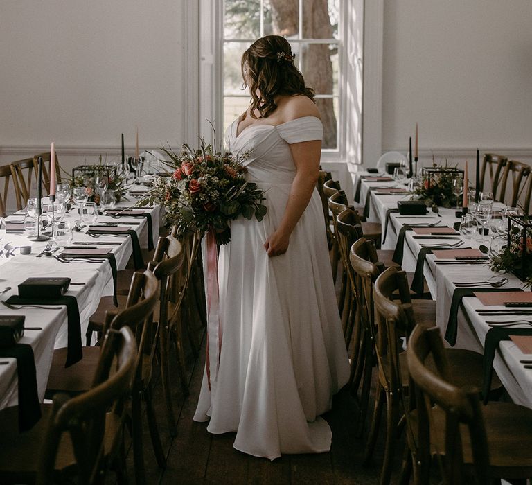 Bride in an off the shoulder Madi Lane wedding dress with her hair in a half up half down hairstyle at Aswarby Rectory wedding venue