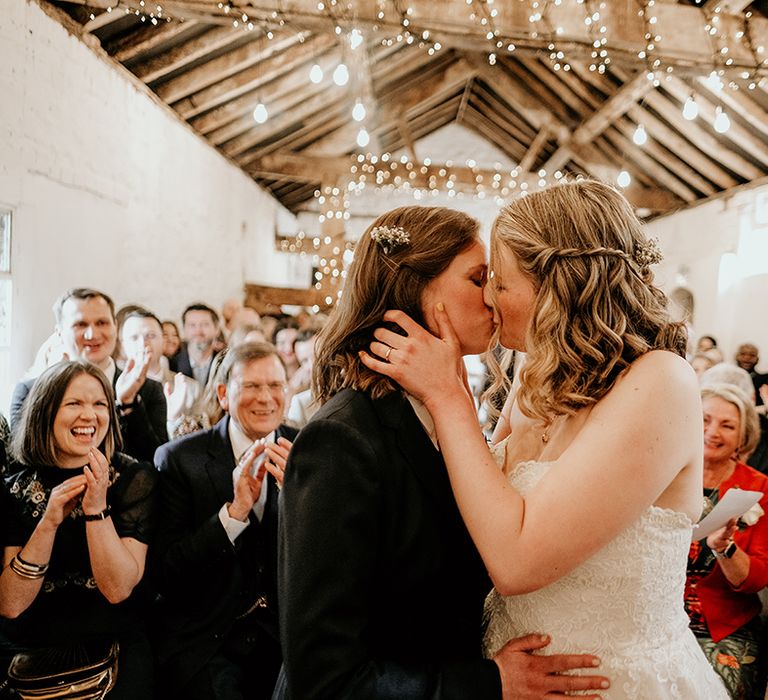 two brides kissing during the wedding ceremony at Stanford Farm wedding 