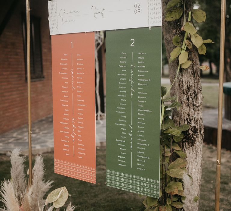 orange and green hanging table plan at destination wedding 