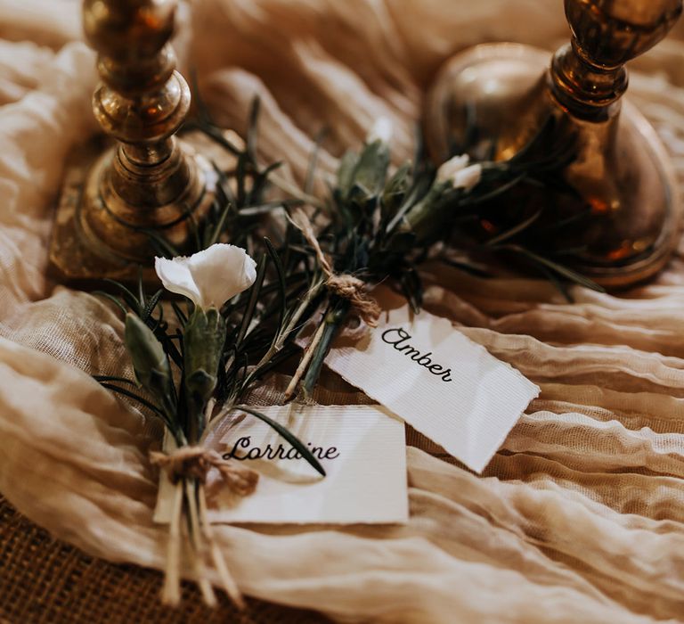 Wedding place name cards on neutral table runner 