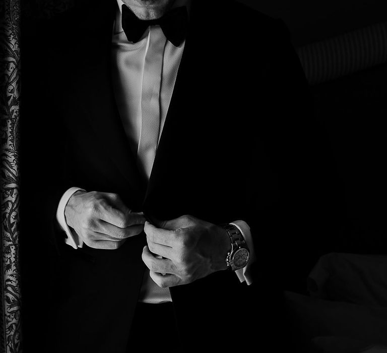 Groom in black and white tuxedo suit for black tie wedding 