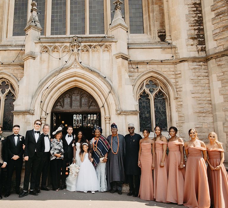 Wedding party group photo with black tie dress code and dusty pink bridesmaid dresses 