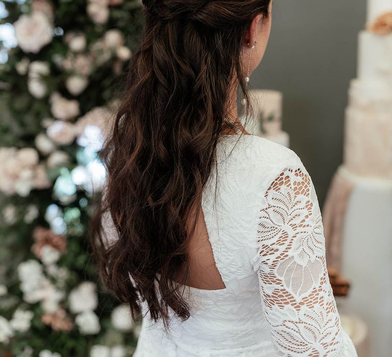 Bride with dark hair in a half up half down princess wedding hair with gold hair accessories 