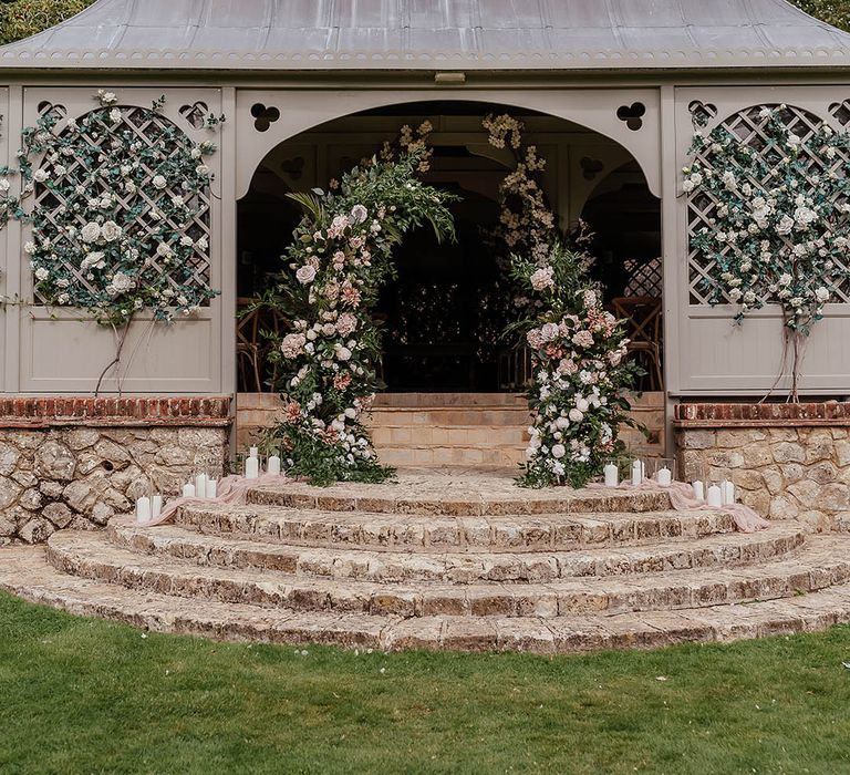 Pink wedding flower column altar decorations at Port Lympne wedding venue in Kent 