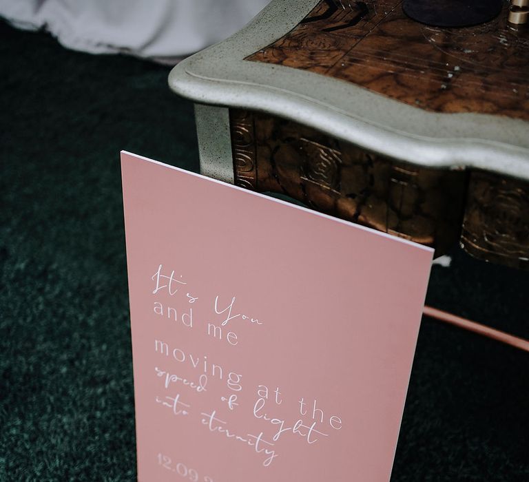 Pink and white wedding sign with quote 