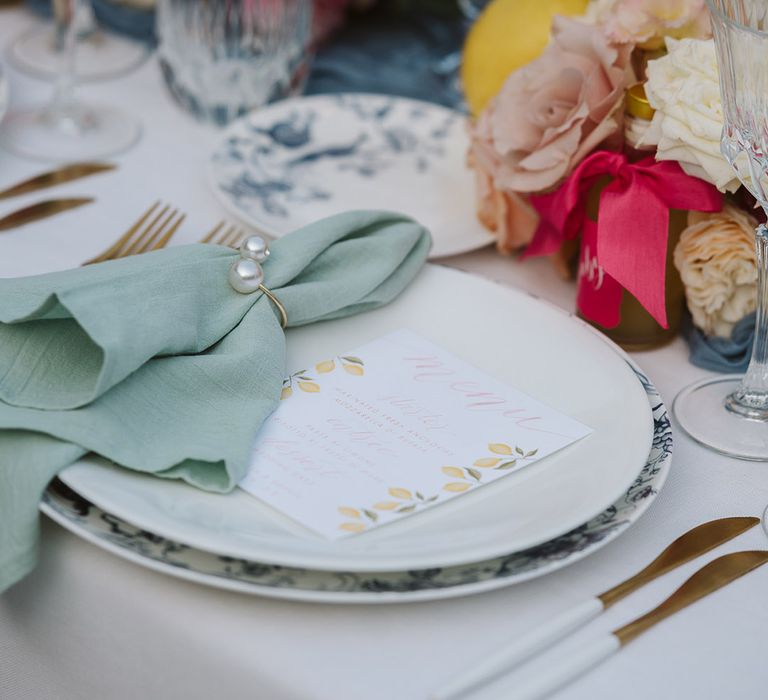 Mint green wedding napkins with a wedding menu decorated with lemon pattern for wedding place setting 