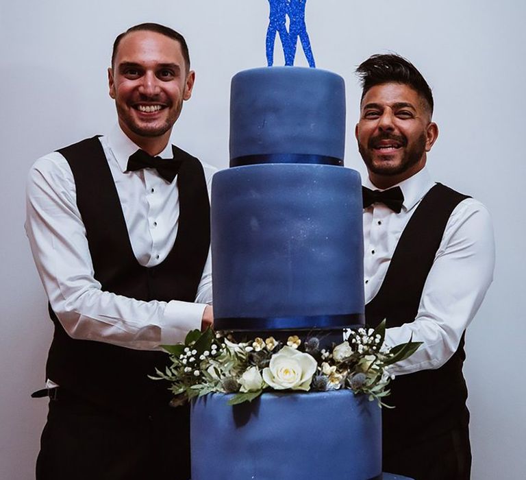 Blue wedding theme at LGBTQI wedding with blue iced wedding cake and blue cake topper 