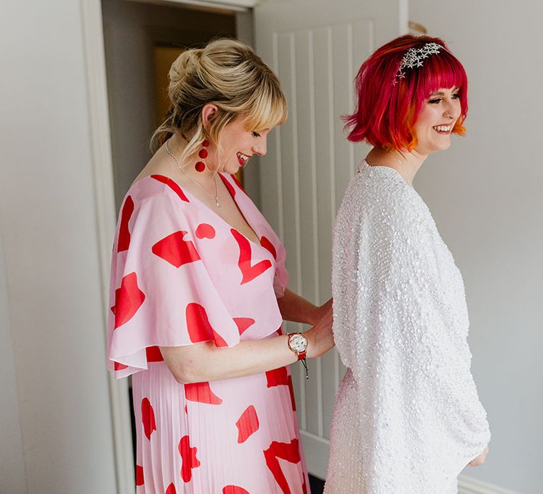 Bride gets ready with bridesmaid in sparkly high street wedding dress 