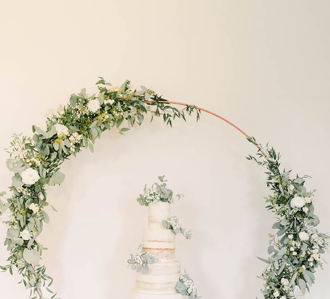 Semi naked wedding cake with floral hoop decor 