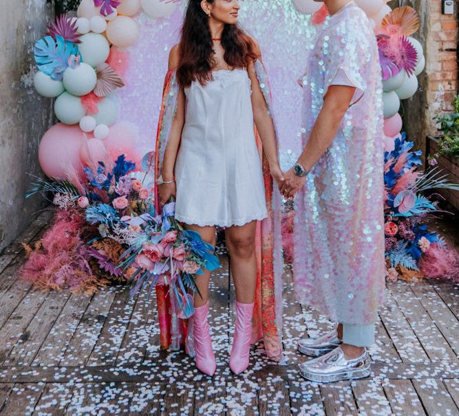 Bride and groom at holographic pastel festival inspiration 