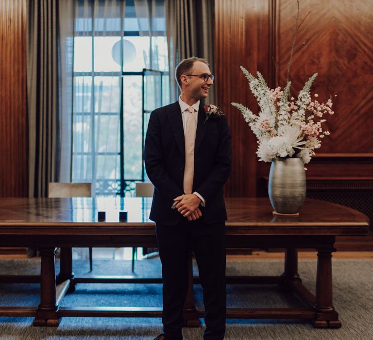 Groom waits patiently for bride at Town Hall wedding