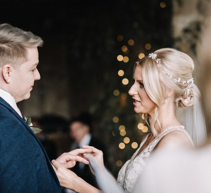 Bride and groom exchanging rings at barn wedding