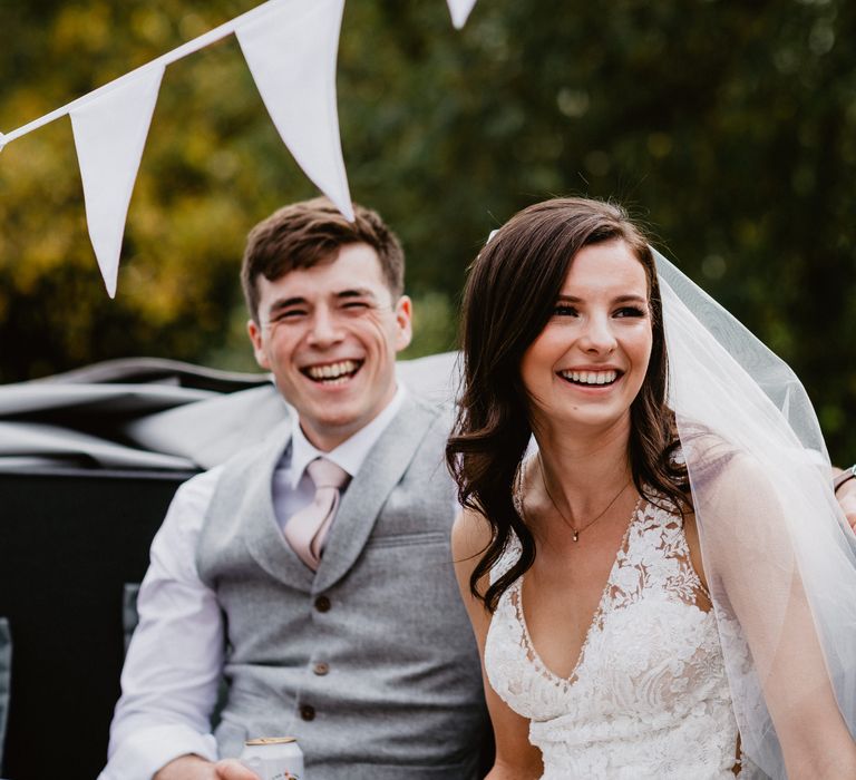 Bride & groom laughing on wedding day 