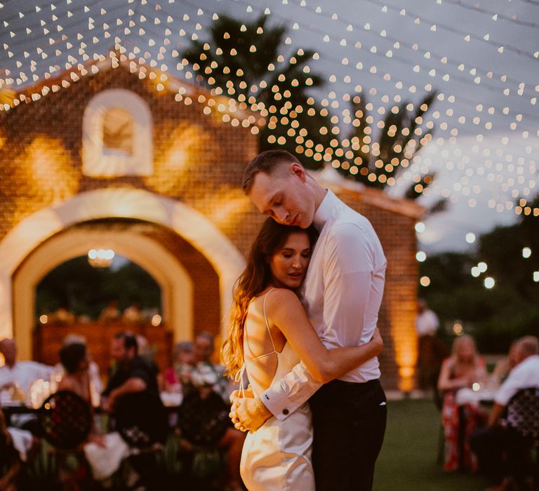 The bride and groom shared their first dance on an outdoor dance floor