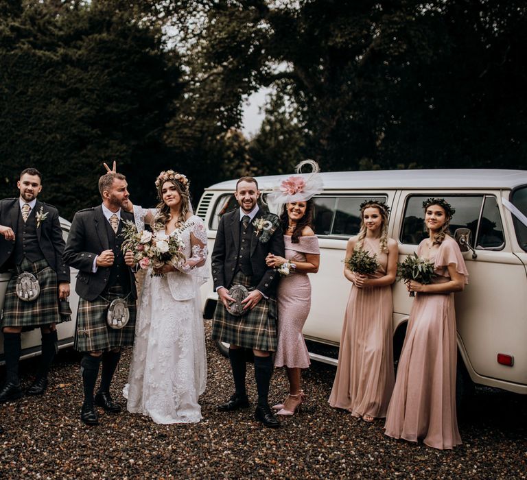 Bridal and groom party standing posing outside in highland wedding in Glencoe 