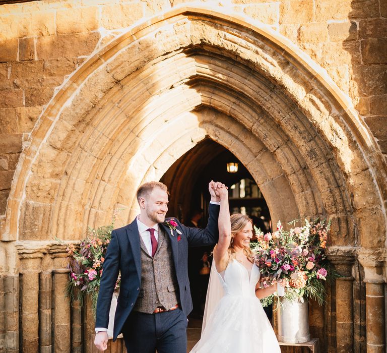 Bride & groom celebrate as they leave the church on their wedding day