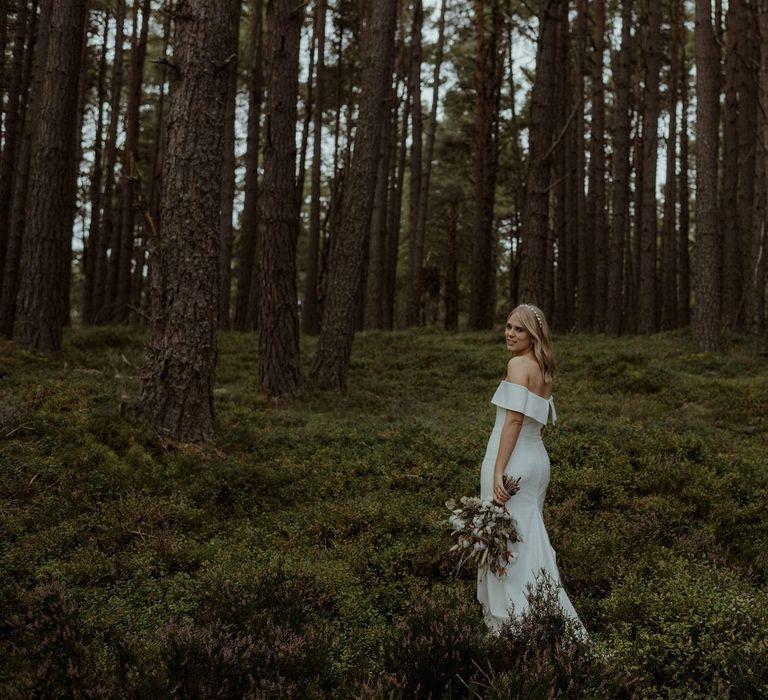 Bride walks through the Scottish forest 