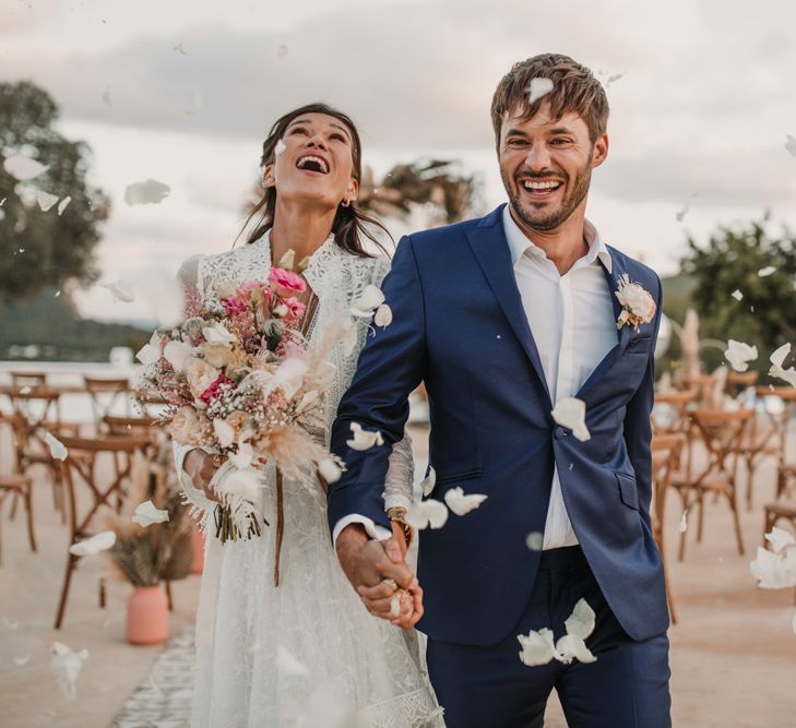 Confetti moment at poolside Ibiza villa wedding ceremony with bride in a Marylise Bridal gown 