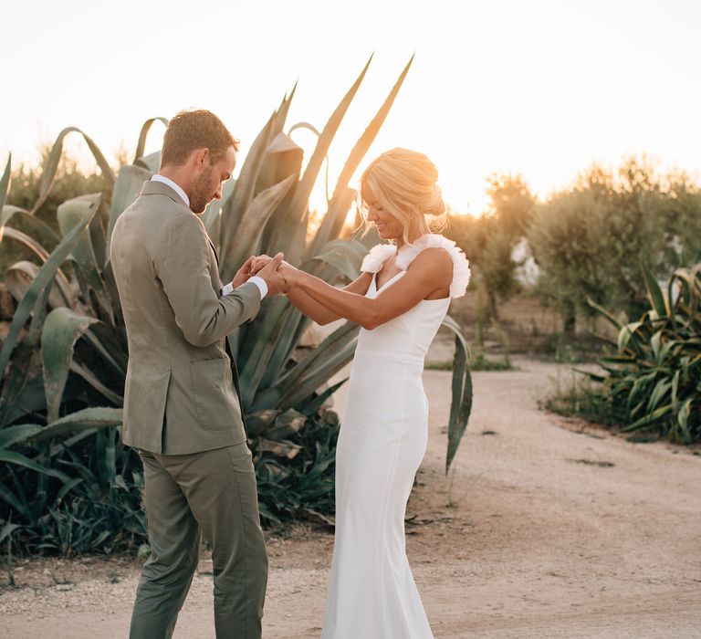 The bride wore a Halfpenny London wedding dress with ruffle straps and the groom wore a grey Thom Sweeney suit