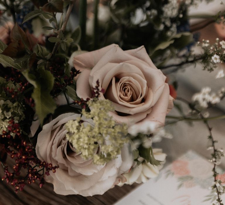 Rustic floral bouquet with roses and green foliage