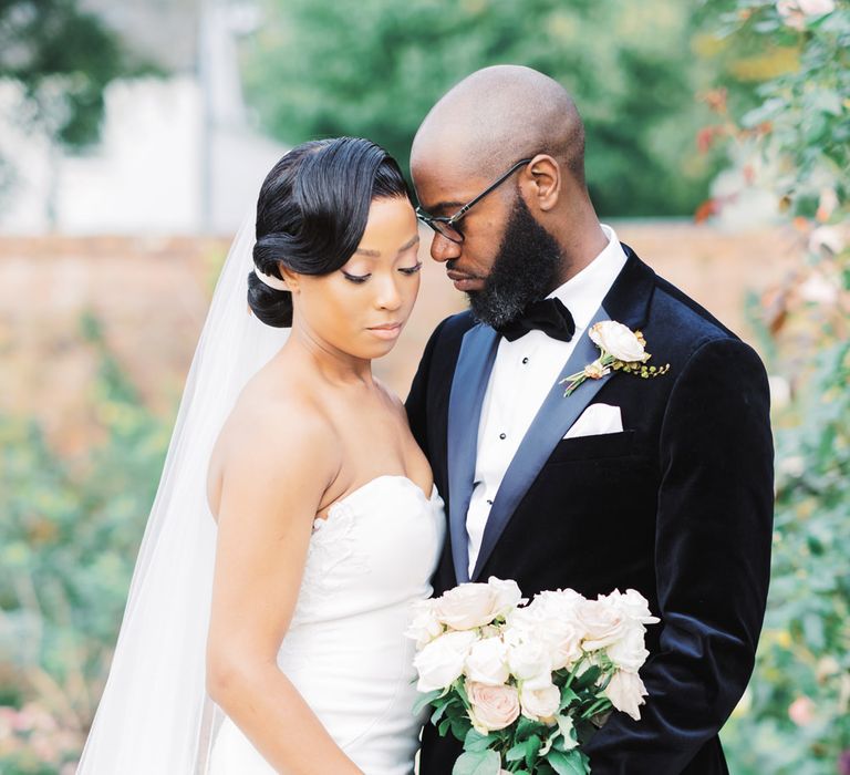 Black bride and Black groom stand together for couple portrait - Classic wedding photographer