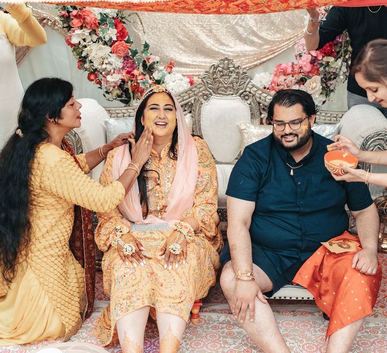 Bride & groom sit together during the Haldi ceremony 