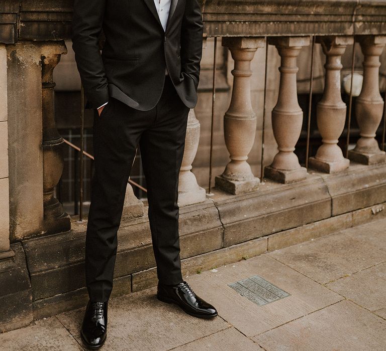 Stylish groom in a Reiss tuxedo with bow tie at intimate Sheffield registry office wedding 